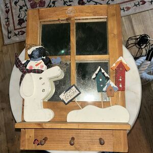 Wooden window pane with snowman and hooks